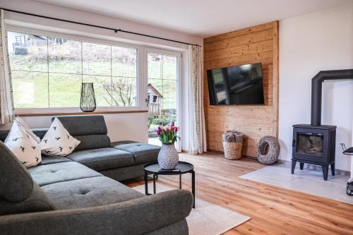a living room with a couch and a fireplace at Ferienwohnung Söldenköpfl-Blick in Schönau am Königssee