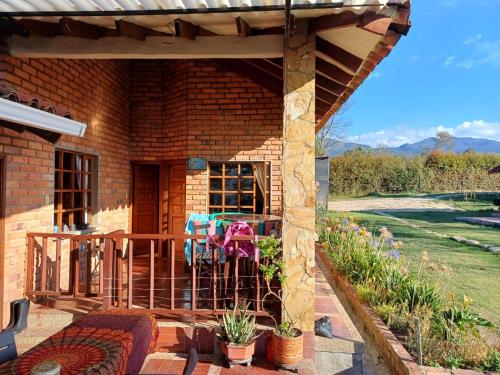 a porch of a brick house with a patio at Mano de Oso Guasca in Guasca