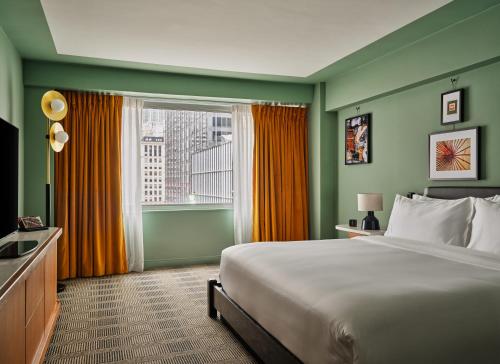 a hotel room with a bed and a window at Romer Hell's Kitchen in New York
