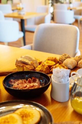 a table topped with a plate of food with a sandwich at Douro Castelo Signature Hotel & Spa in Lamego