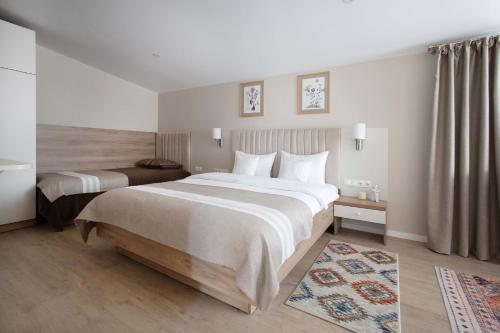 a hotel room with two beds and a rug at CASA ENCIAN in Colibiţa