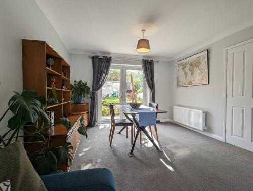 a living room with a table and chairs and a window at Moorside Terrace in Guisborough
