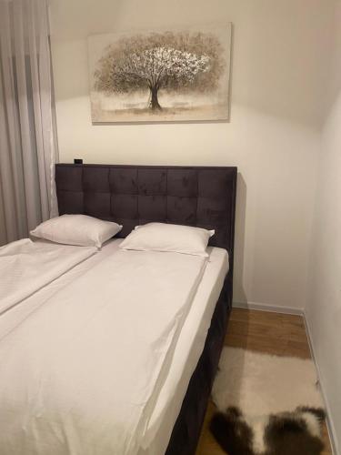 a bedroom with a bed with a tree in the background at GO Jahorina by Olympic Gardens in Jahorina