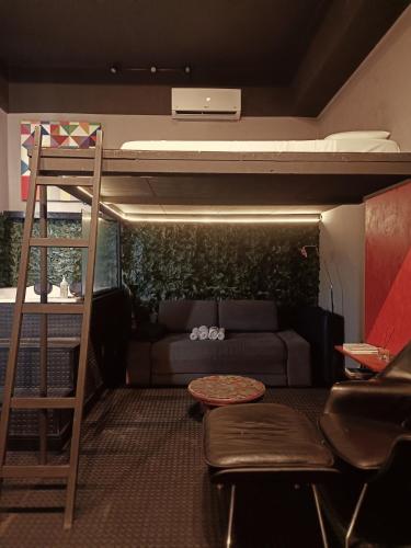 a room with a bunk bed and a couch at Loft Sagitárius - Central Zone - Lotk1 in Rio de Janeiro