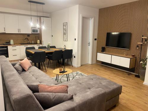 a living room with a couch and a dining room at GO Jahorina by Olympic Gardens in Jahorina