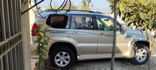 a silver suv parked next to a building at E- Town Guest House karachi in Karachi