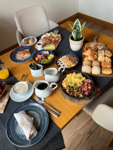a table with many plates of food on it at Douro Castelo Signature Hotel & Spa in Lamego
