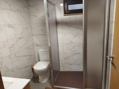 a bathroom with a toilet and a shower at Casa Souto in Santa Comba