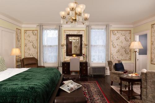 a bedroom with a green bed and a chandelier at 300 Clifton in Minneapolis