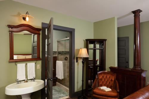 a bathroom with a sink and a shower and a mirror at 300 Clifton in Minneapolis