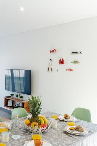 a table with fruits and plates of food on it at SAL Baleal in Baleal
