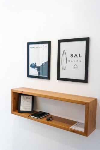 a wooden shelf with two pictures on a wall at SAL Baleal in Baleal