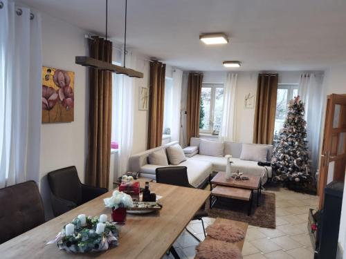 a living room with a christmas tree and a couch at Kuća za odmor La Vi in Mrkopalj