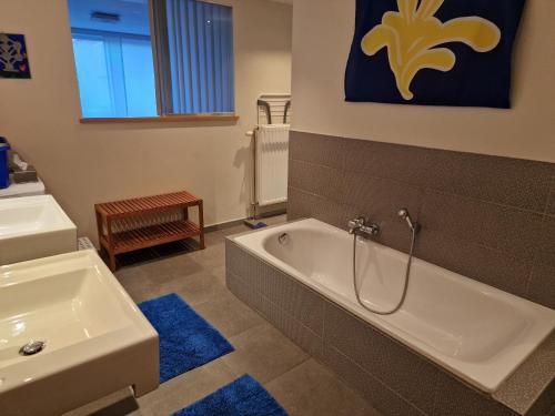 a bathroom with a bath tub and a sink at Apartment Home Frit Home in Brussels