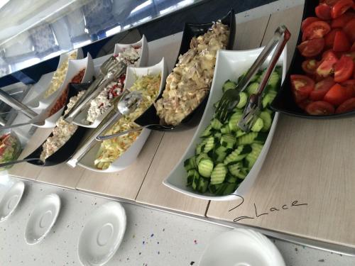 a table with plates of food and fruits and vegetables at Palace Hotel - Half Board in Sunny Beach