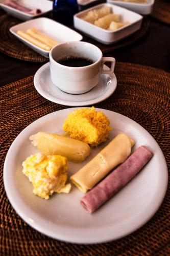 サルバドールにあるカーサ ペチュニア ポサーダ ブティックの朝食用の食品とコーヒー