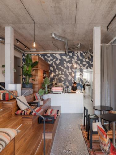 a living room with couches and a kitchen at ArtBau Designhotel in Waldkirch
