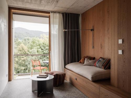 a bedroom with a bed and a large window at ArtBau Designhotel in Waldkirch