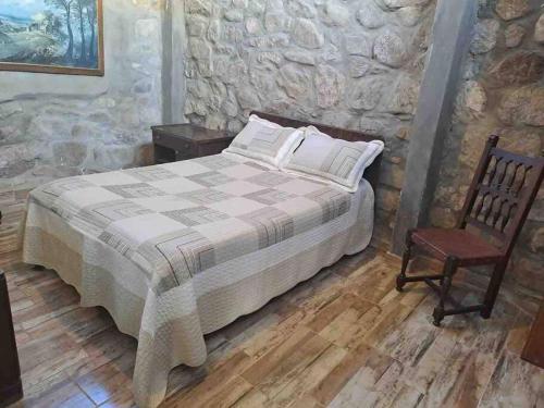 - une chambre avec un lit et une chaise dans l'établissement El Vergel, à Villa Giardino