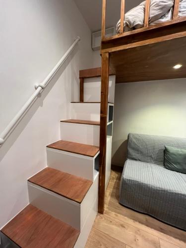 a staircase leading up to a bunk bed in a room at Charme Cosy au Cœur de Paris in Paris