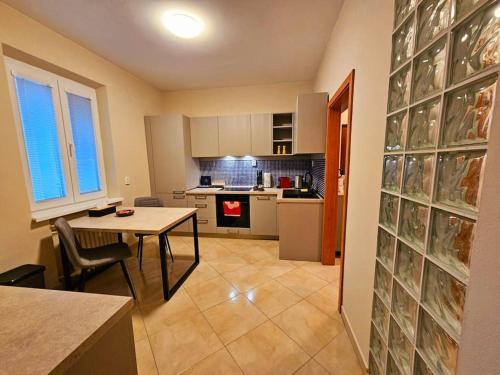 a kitchen with a table and a dining room at Prime Location! Fan's paradise in Koliba