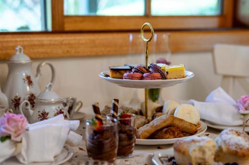 a table with a plate of pastries on a table at Mountain Lodge in Mount Dandenong