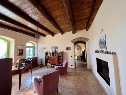 a living room filled with furniture and a fireplace at Panoramic villa with pool in Bolsena