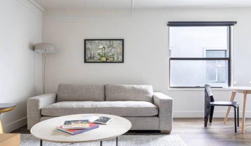 a living room with a couch and a table at Reside Seattle Downtown, a Wyndham Residence in Seattle