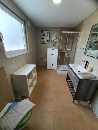 a large bathroom with a shower and a sink at Apartment Weizblick in Oberdorf bei Thannhausen