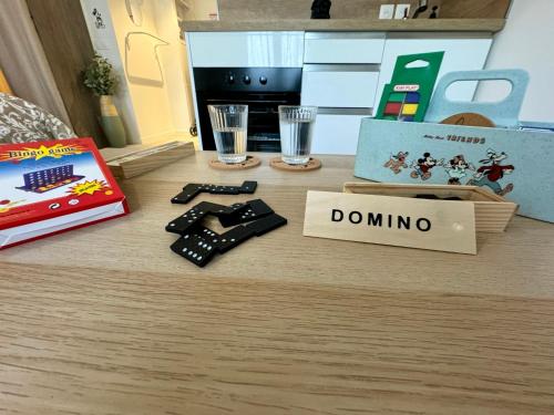 a table with a game controller and a donation box at Magic Appartement Disneyland in Serris
