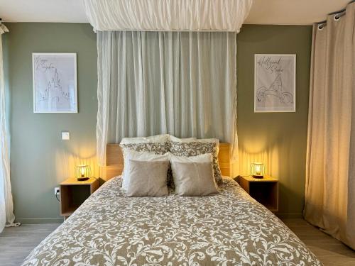 a bedroom with a large bed with two night stands at Magic Appartement Disneyland in Serris