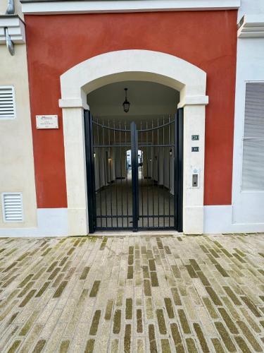 an entrance to a building with a black gate at Magic Appartement Disneyland in Serris