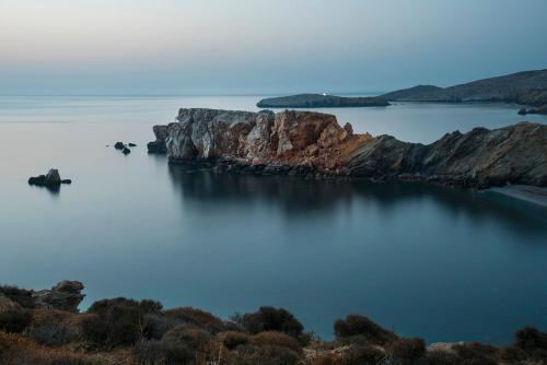 an island in the middle of a body of water at Onar Suites & Villas in Karavostasi