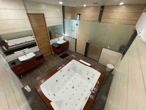 a large bathroom with a large tub and a sink at Villa Vista - with Pool & Jaccuzi in Kundakal