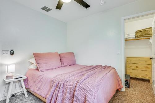 a bedroom with a pink bed and a mirror at Gorgeous Green Valley Home Patio and Private Pool! in Green Valley