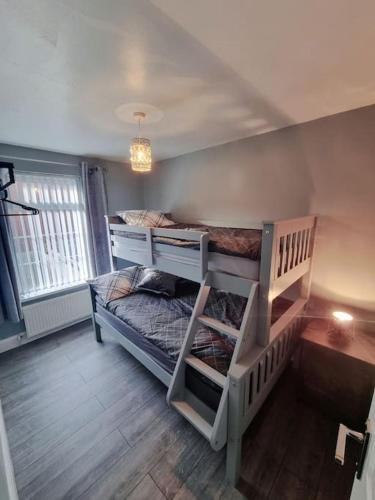 a bedroom with two bunk beds and a window at Rise at the International Wall Belfast in Belfast