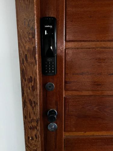 a wooden door with a cell phone on it at Suíte na Passarela do Álcool in Porto Seguro