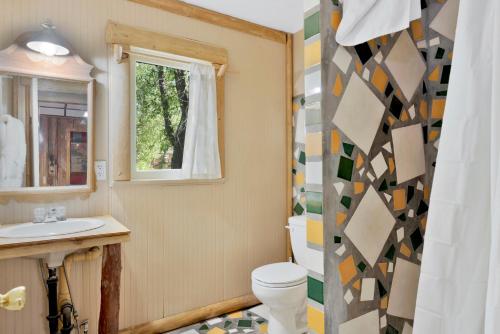 a bathroom with a toilet and a sink at Lodge House-Family Cabin with Pool Table by Big Bear Vacations in Big Bear Lake