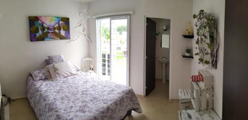 a bedroom with a bed and a large window at Casa Adhita, tú confort es nuestra prioridad. in Yautepec