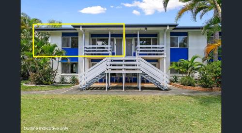 a blue and white house with a white and yellow porch at Seabreeze at Silver Sands Hervey Bay in Hervey Bay