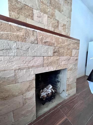 a stone fireplace in a living room at Güemes Apart in San Juan