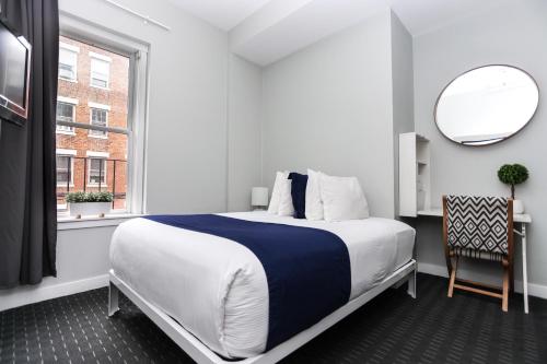 a bedroom with a large bed and a window at Cozy Studio on Newbury Street, #1 in Boston