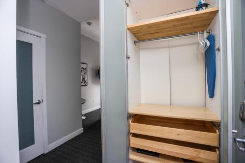 a closet with white cabinets and wooden steps at Cozy Studio on Newbury Street, #1 in Boston