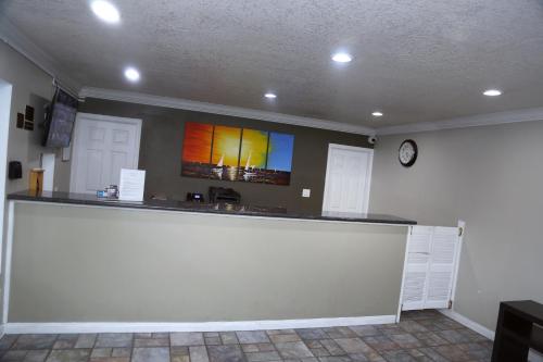 a bar in a room with a clock on the wall at Anaheim Executive Inn & Suites in Anaheim