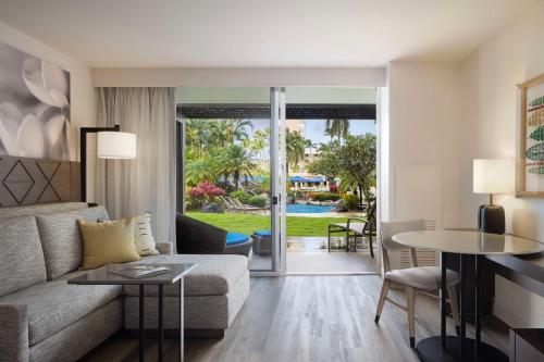 a living room with a couch and a table at The Royal Sonesta Kauai Resort Lihue in Lihue