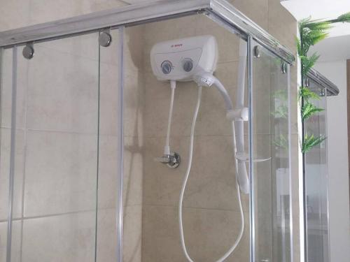 a shower with a shower head in a bathroom at Aparta estudio en la candelaria WiFi rápido-a pasos del museo de oro in Bogotá