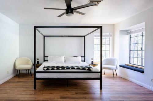 una camera con un letto e due sedie e un ventilatore a soffitto di Apres-Ski Chalet Mt High Wrightwood Ski Resort a Wrightwood
