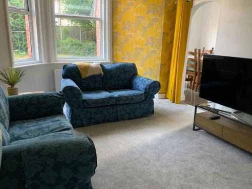 a living room with a couch and a tv at Family friendly flat, Perfect for a Dorset escape in Bournemouth