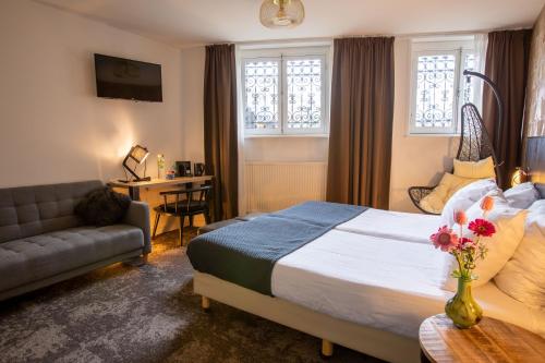 a hotel room with a bed and a couch at Boutique Hotel View in Amsterdam
