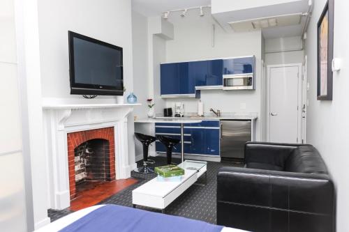 a living room with a couch and a fireplace at Stylish Newbury Street Studio, #2 in Boston
